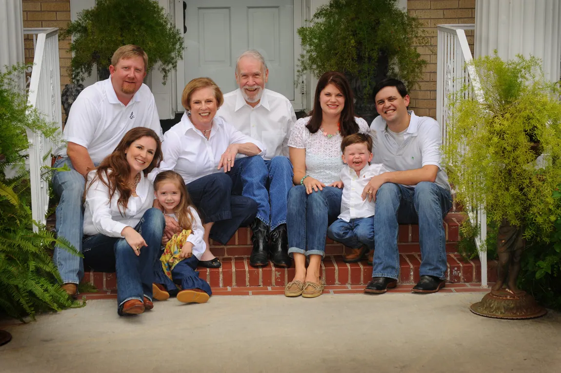 Extended family with grandparents and grandchildren on a brick porch