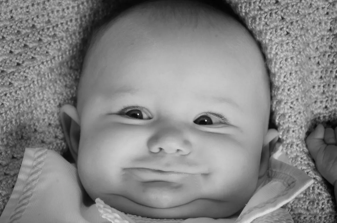 Black-and-white portrait of a chubby-cheeked baby