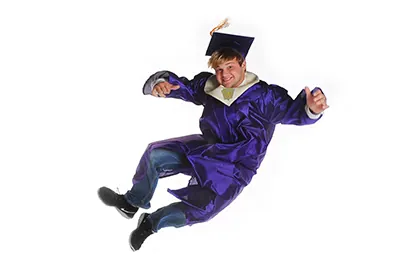 Graduate in a purple cap and gown jumping in midair on a white background