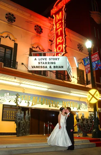 Couple kissing under a theater marquee reading A Love Story Starring Vanessa and Brian